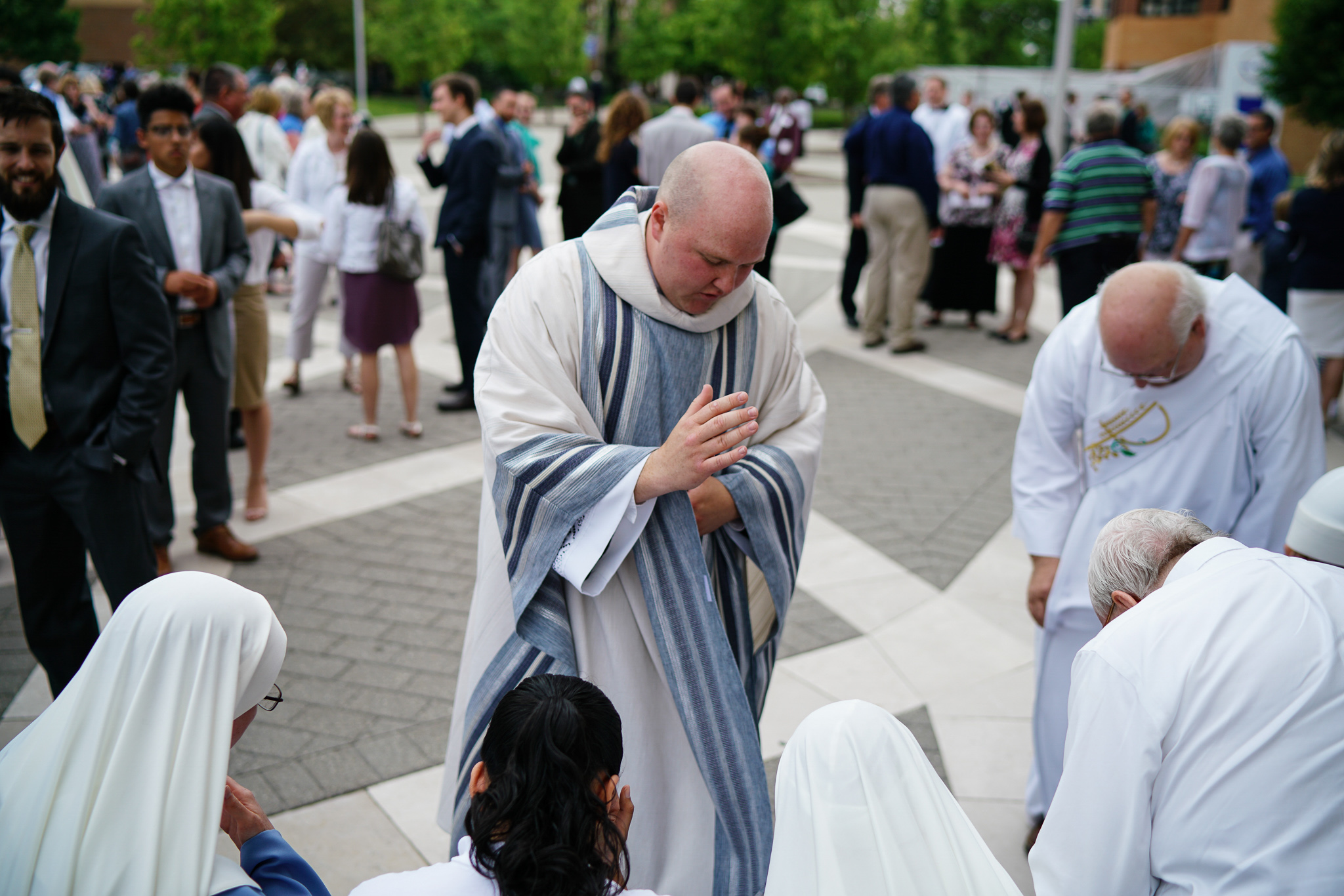 father stephen durkee gives a blessing to the crowd following his ordination to the priesthood
