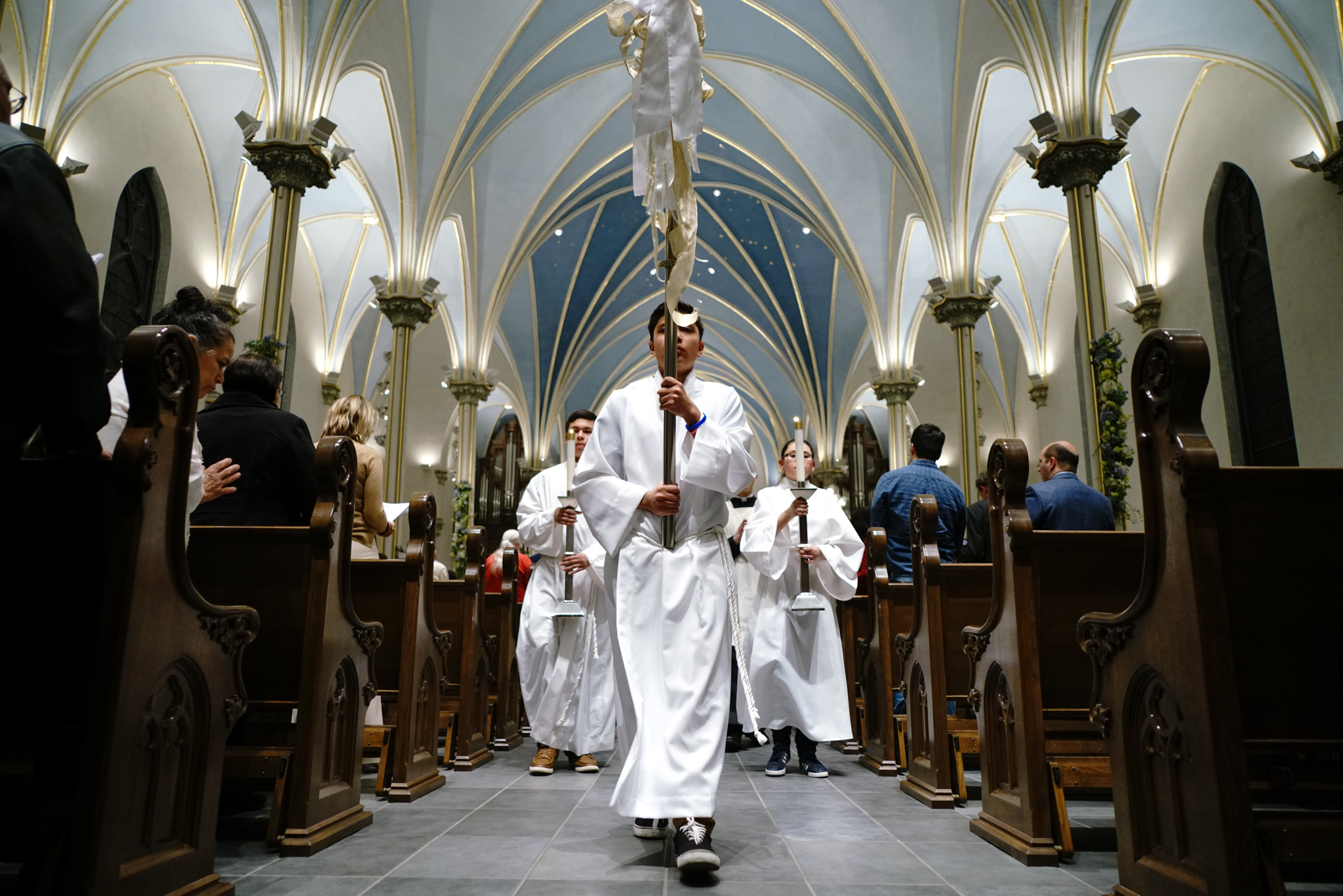 Altar servers recess out of the Cathedral after the Easter Vigil Mass.