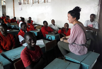 Maryknoll lay missioner teaches a classroom of young people