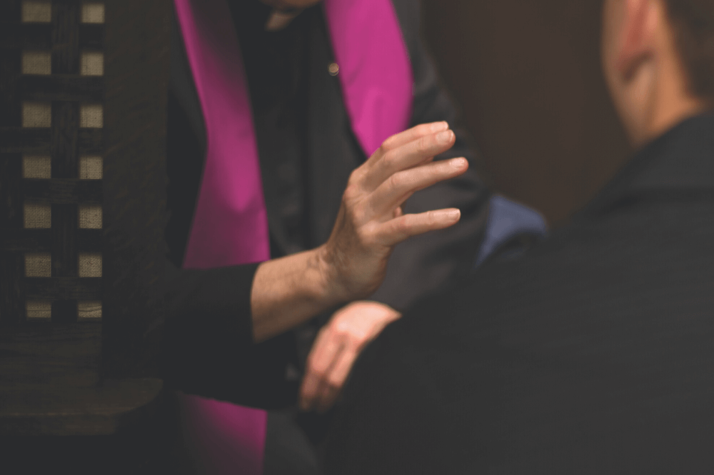 Image of a priest giving absolution during confession