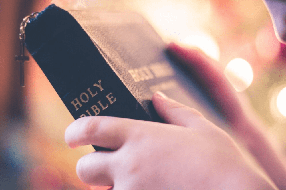 Image of hands holding a Holy Bible