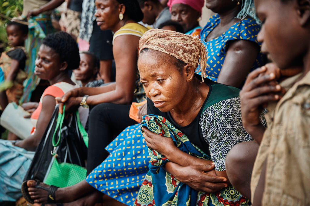 Cameroonian refugees and Nigerians wait for consultations outside a health post April 13 in the Nigerian village of Ekang. Caritas Internationalis reported the conflict in Cameroon has forced 160,000 people out of their homes into the bush and a further 26,000 to cross into Nigeria. (CNS photo/courtesy Caritas Internationalis) May 23, 2018.