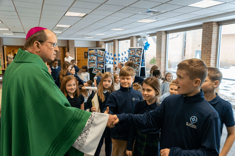 Bishop Walkowiak greets students following Mass at St. Anthony of Padua, Jan. 2020