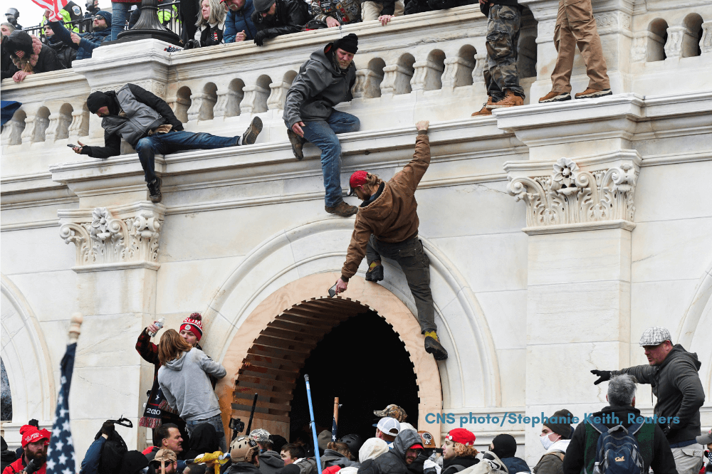 Supporters of President Donald Trump climb on walls at the U.S. Capitol in Washington Jan. 6, 2021, by Stephanie Keith, Reuters