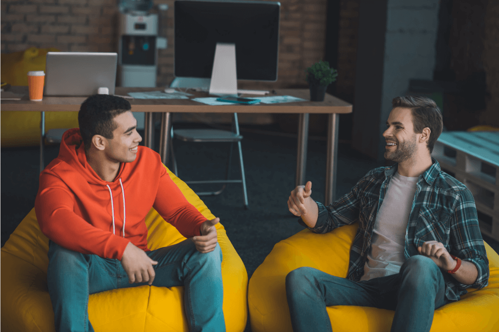 Two young adult males hanging out, talking