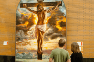 Couple in front of Mia Tavonatti's Crucifixion, ArtPrize 2011 entry