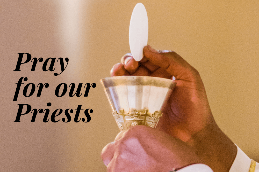 Hands of a priest elevating the host and chalice