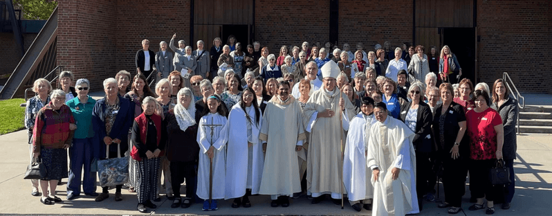 Bishop Walkowiak with Father Ayub, pastor of St. Jude, in group photo with members of the Grand Rapids Diocesan Council of Catholic Women and attendees of their 2022 conference.