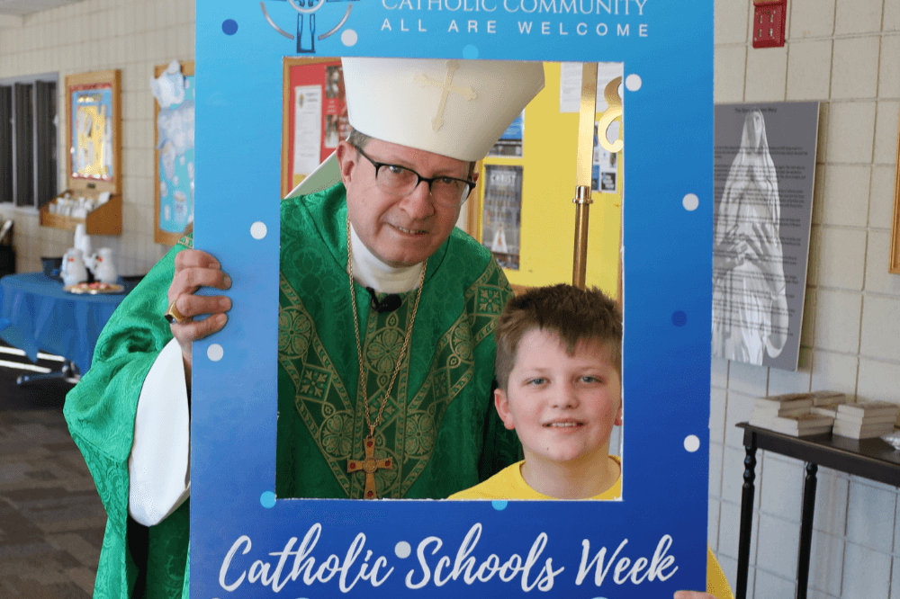Bishop Walkowiak at St. Anthony for CSW23 with student "priest for a day" Tommy.