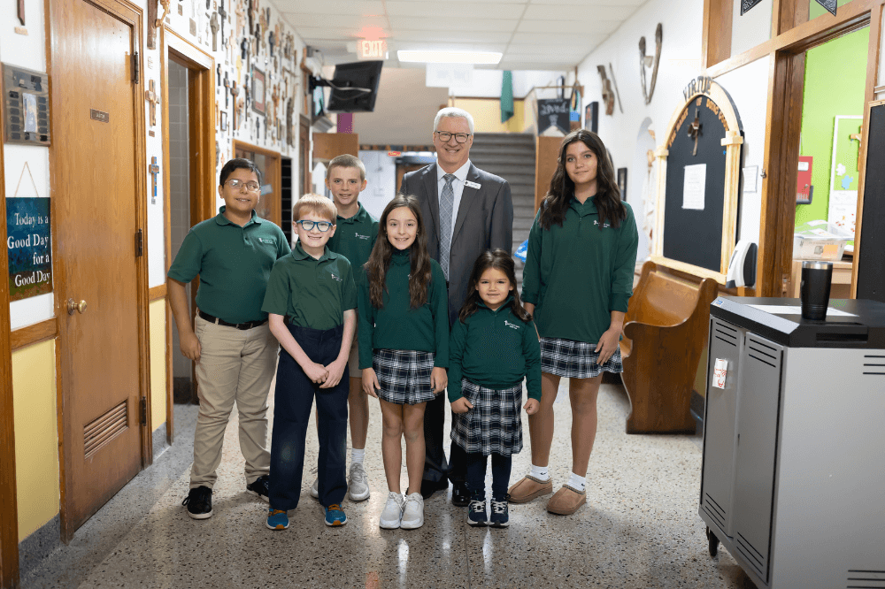 Superintendent David Faber poses with a group of students from St. Thomas the Apostle Catholic School in Grand Rapids, Michigan.