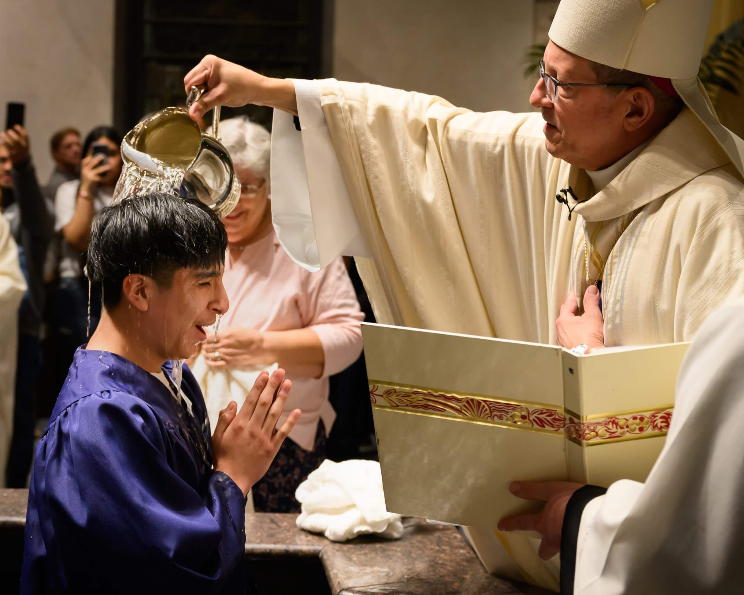 Bishop Walkowiak baptizes a gentleman at the Cathedral of Saint Andrew during Easter Vigil 2024
