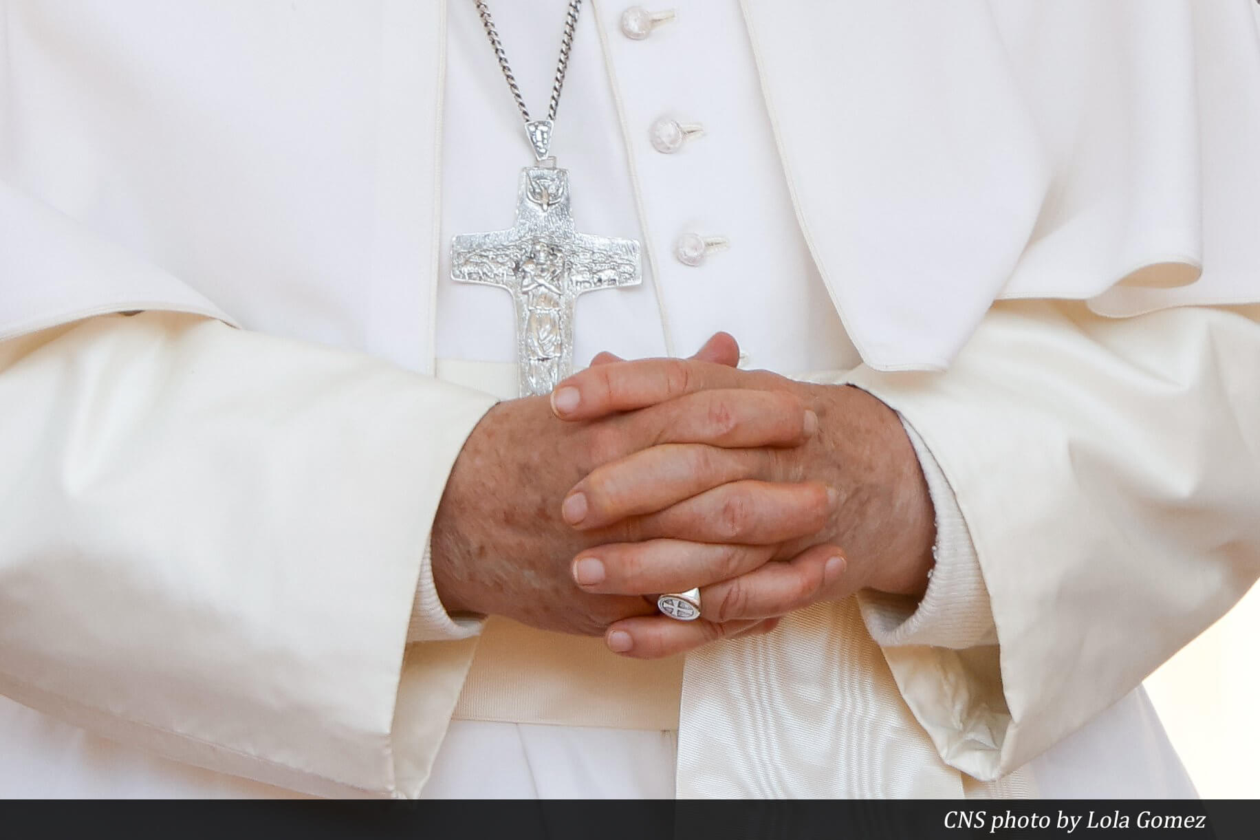 Pope Francis prays with his hands clasped in front of his pectoral cross during his weekly general audience in St. Peter's Square at the Vatican May 15, 2024. (CNS photo/Lola Gomez)